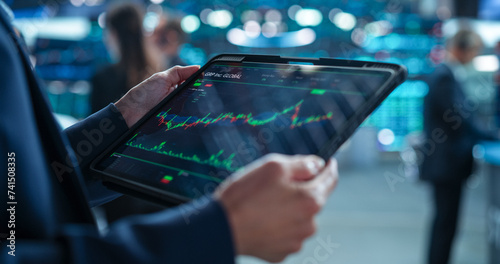 Anonymous Person Holding a Tablet Computer with Stock Market Analytics, Graphs and Reports on Screen. Stock Exchange Application Template. Banker Monitoring Financial and Business Opportunities