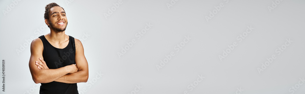 handsome joyful african american man in sportwear posing with his arms crossed on chest, banner handsome joyful african american man in sportwear posing with his arms crossed on chest, banner