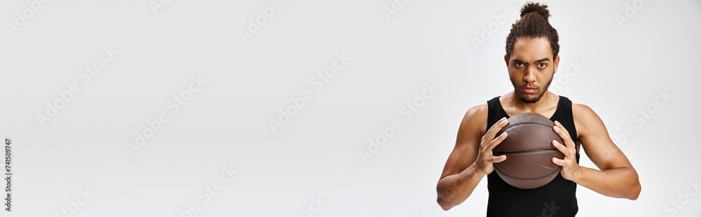 athletic african american man in cozy sportwear holding basketball and looking at camera, banner athletic african american man in cozy sportwear holding basketball and looking at camera, banner
