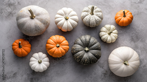 A group of pumpkins on a light gray color stone
