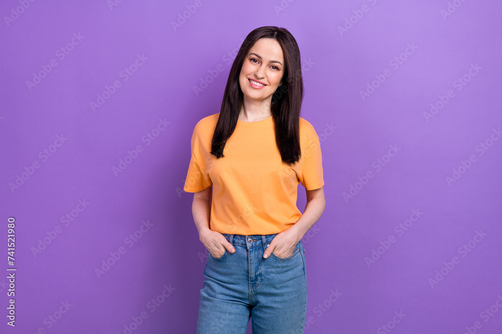 Portrait of adorable lovely girl with stylish hairdo wear oversize t-shirt holding arms in pockets isolated on violet color background Portrait of adorable lovely girl with stylish hairdo wear oversize t-shirt holding arms in pockets isolated on violet color background