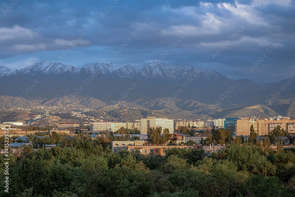 Scenic Cityscape with Majestic Snow-Capped Mountains