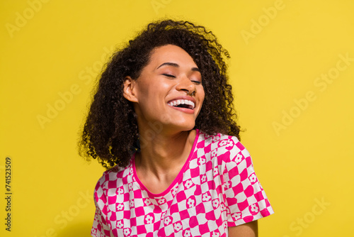 Portrait of adorable cheerful girl closed eyes dream toothy smile laughing isolated on bright yellow color background © deagreez