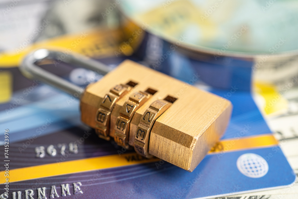 Credit card with password key lock and US dollar banknotes.