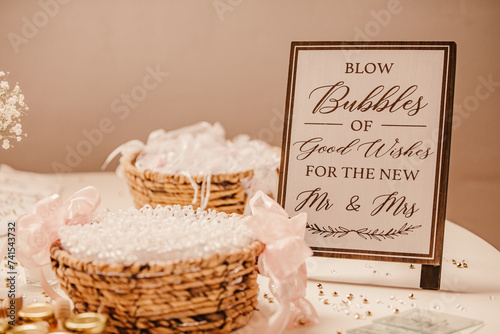 Wedding favors and wedding bubbles on a decorated table of a wedding.