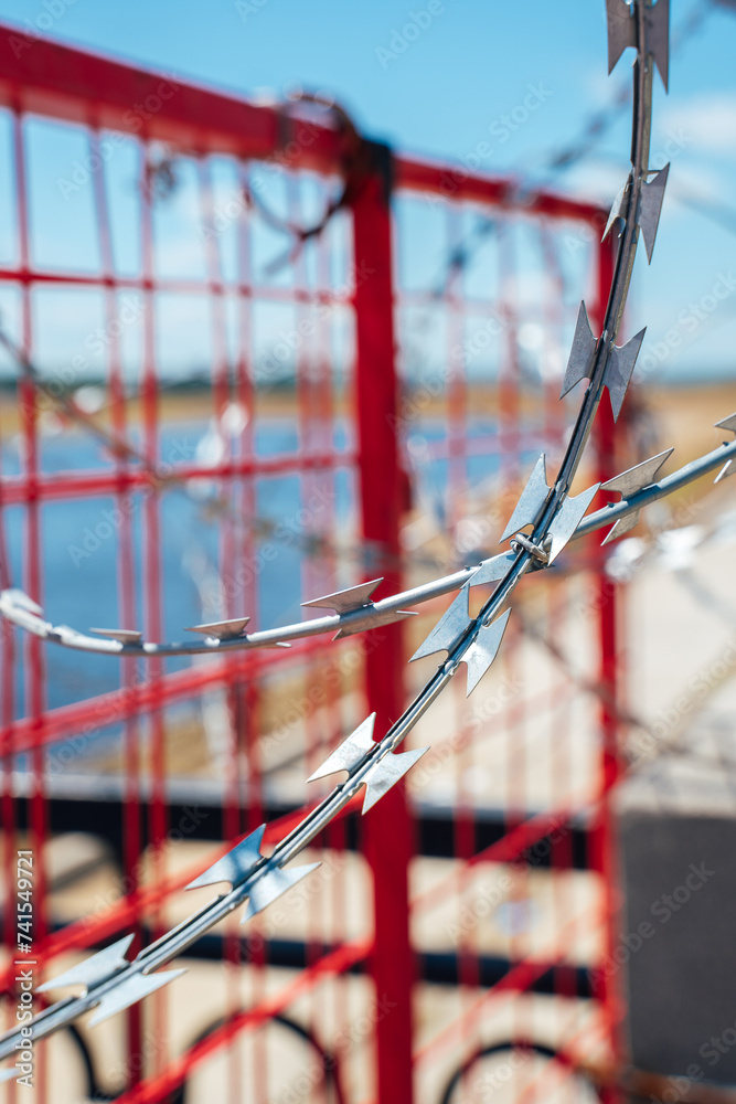 Fence with barbed wire. No entry. The border is guarded Fence with barbed wire. No entry. The border is guarded