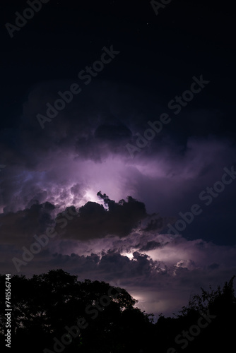Beautiful cloud formation over a suburban home area with lightning striking within its self showing a very ominous scene. looks like lightning trying to escape out of the side. 