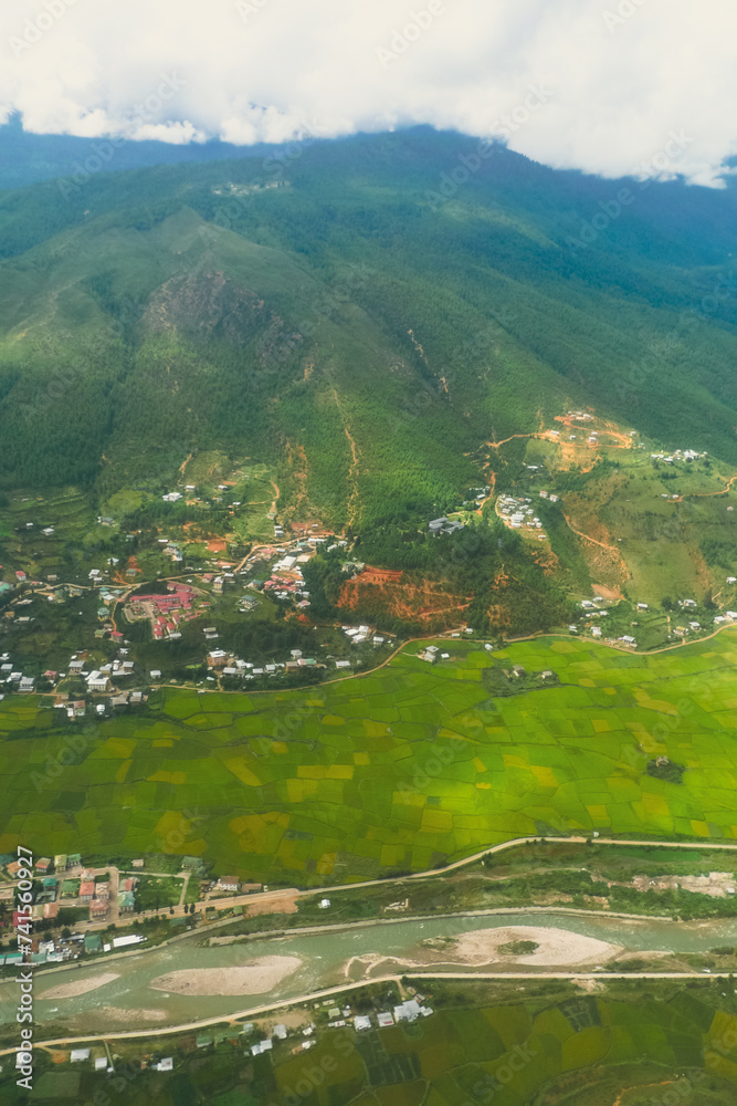 Mountainous landscape shot Aerial view of settlement and vegetation in Bhutan