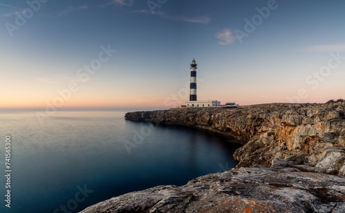 view of the landmark Cap d'Artrutx lighthouse on Menorca Island just after sunrise
