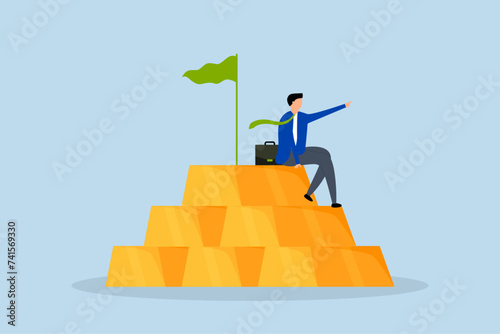 Gold investment, businessman, wealth manager, trader, or wealthy investor sits atop a stack of gold bar bullion.