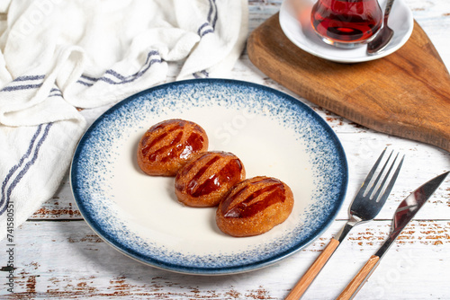 Sekerpare or badempare dessert on a white wood background. Traditional Turkish cuisine flavors. ramadan dessert photo