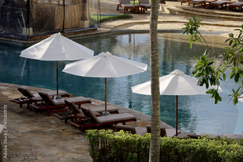 beach umbrellas and lounge chairs by the pool, vacation, travel and enjoy free time in comfort and peace.