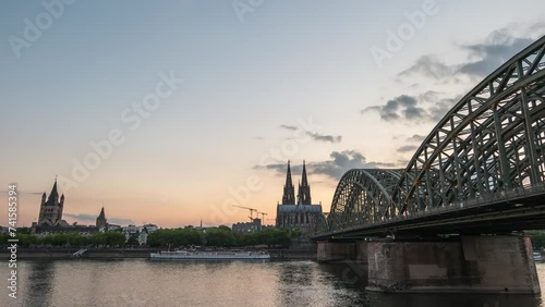 Cologne (Koln) Germany time lapse, day to night sunset city skyline at Cologne Cathedral (Cologne Dom) with Rhine River and Hohenzollern Bridge photo