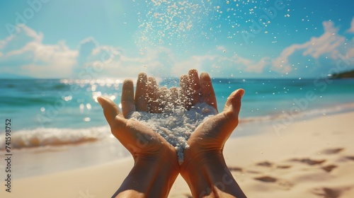 Hands releasing dropping sand. Sand flowing through the hands against blue ocean. Summer beach holiday vacation concept #741598752