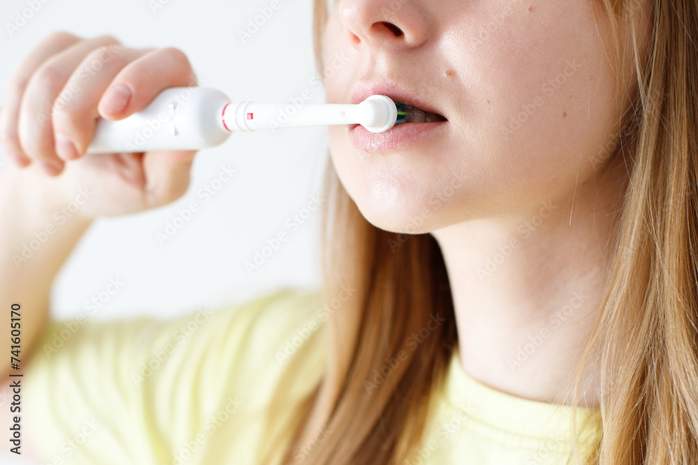Woman in dental care with electric toothbrush Woman in dental care with electric toothbrush