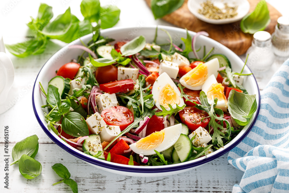 Egg and arugula fresh vegetable salad with feta cheese