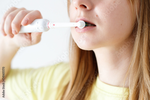 Woman in dental care with electric toothbrush