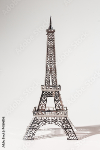 Fototapeta Naklejka Na Ścianę i Meble -  Delicate metal Eiffel Tower model on white background