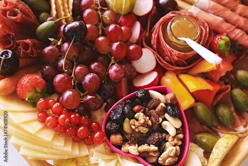 Antipasto platter with meat, chease, fruits, vegetables and nuts. Appetizer, catering food concept photo