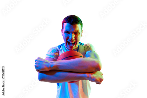 Intense basketball player with competitive expression clutching ball with fierce against white studio background in neon light. Concept of sport games, energy, strength and power, match, tournament. photo