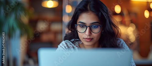 Young adult indian woman distance teacher tutor job applicant talking by video conference call using laptop computer work from home office Virtual chat meeting web counseling remote job intervi photo