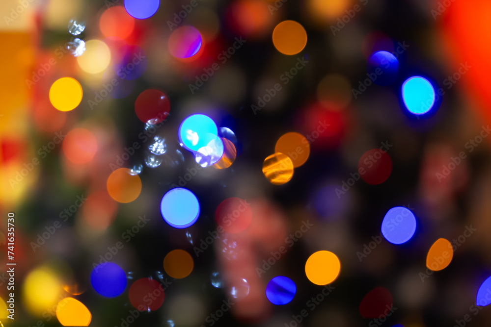 Colorful Christmas spots sideways from the Christmas tree garland.