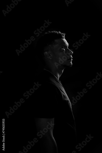Obraz na płótnie Low key of young African American man in profile. black and white photography w salonie