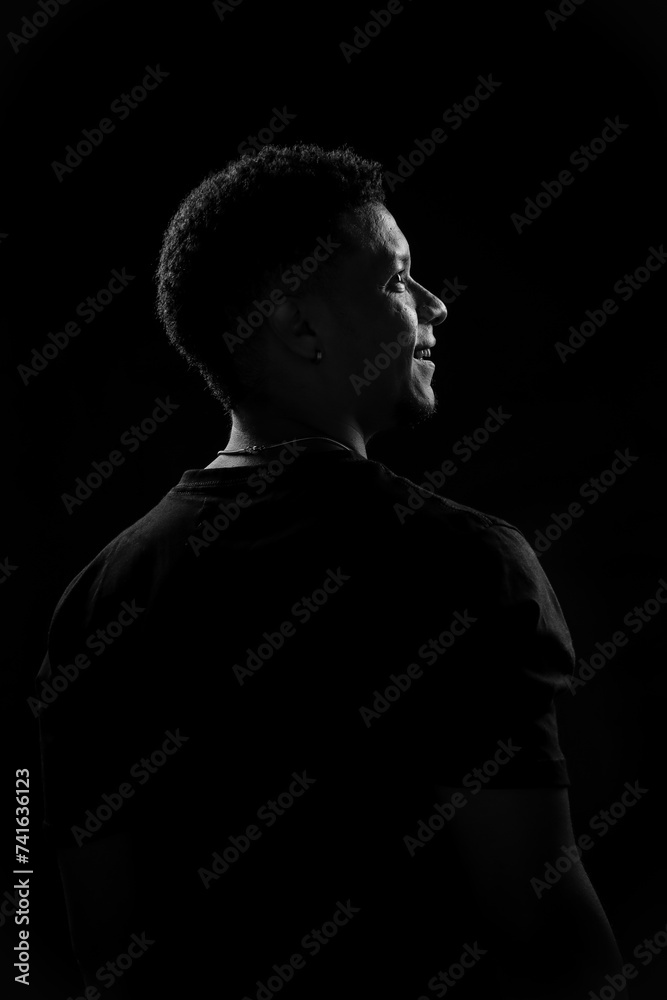 Low key of young Brazilian man in profile. black and white photography