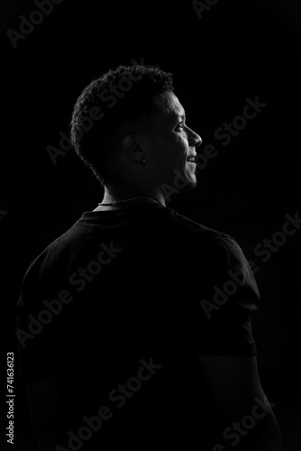 Low key of young Brazilian man in profile. black and white photography