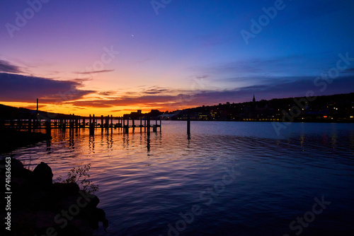 Blue Hour Waterfront with Pier Reflection and Crescent Moon, Houghton