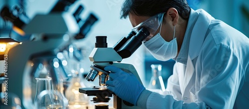 Microbiologist examining bi...