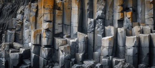 basalt columns forming a coastal rock at Cape Stolbchaty on Kunashir Island close up. with copy space image. Place for adding text or design photo