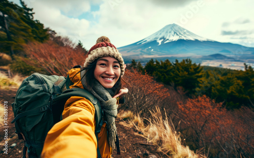 Fuji Explorer: An Influencer's Odyssey - A Young Woman Chronicles Her Adventure with a Backpack Selfie near Mount Fuji in Tokyo, Japan, Embracing Nature's Spectacle.