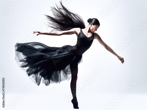 Ballerina in black dress dancing elegantly on white background