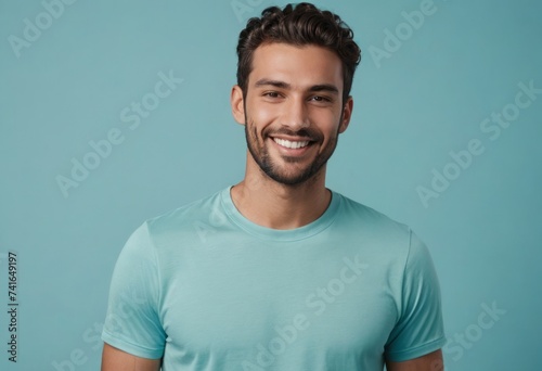 A happy man with a bright smile, wearing a teal t-shirt, exudes a friendly vibe.