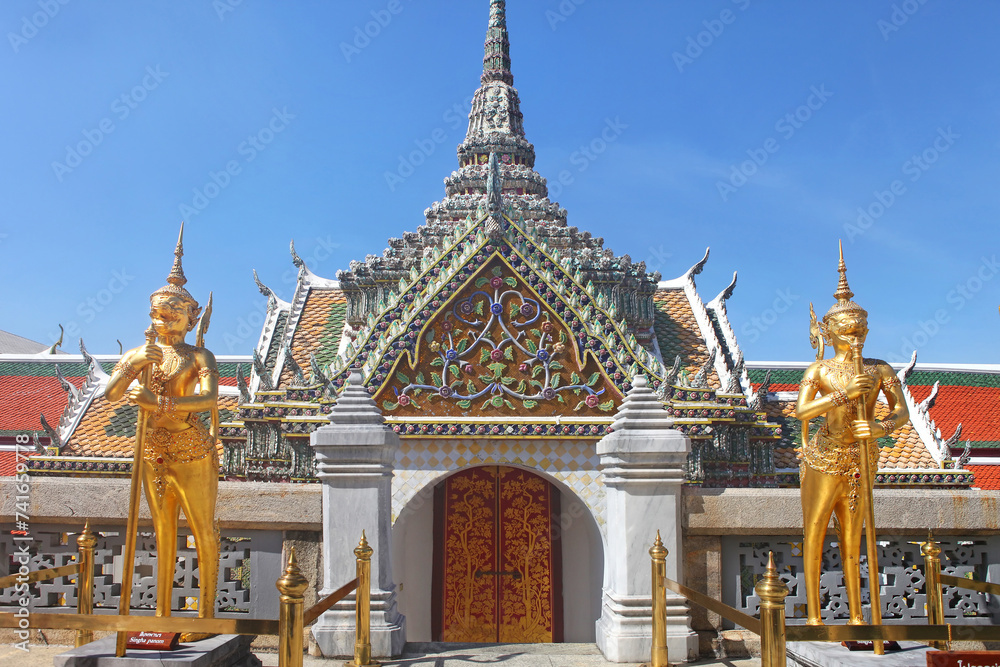 Fototapeta premium Two giant monkey gardians called Singha Panorn guarding the entrance of a temple in the Wat Phra Kae complex