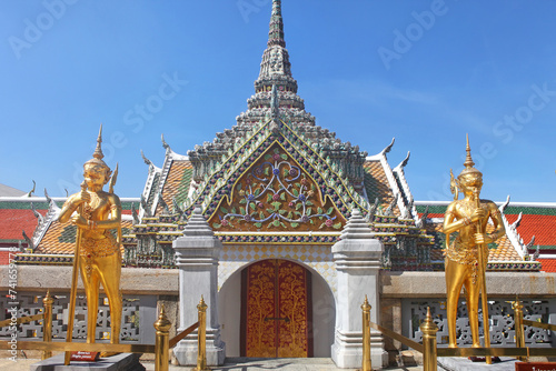 Two giant monkey gardians called Singha Panorn guarding the entrance of a temple in the Wat Phra Kae complex