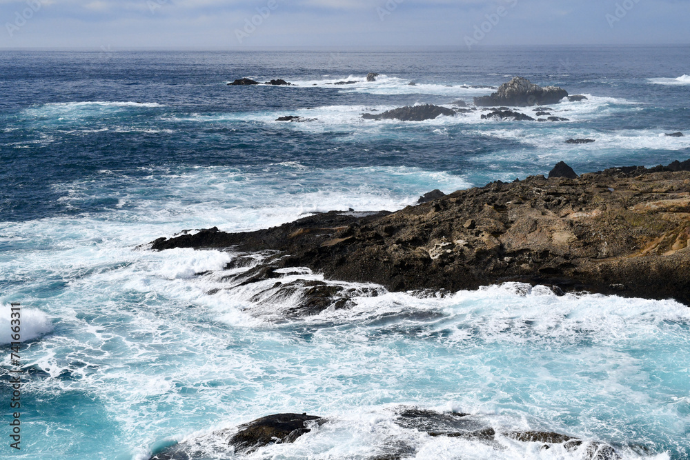 Waves splashing along the rocky California ocean coastline