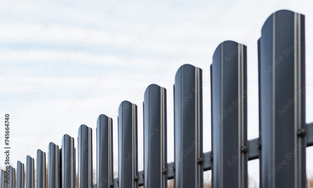 New fence made of dark-colored metal profile New fence made of dark-colored metal profile