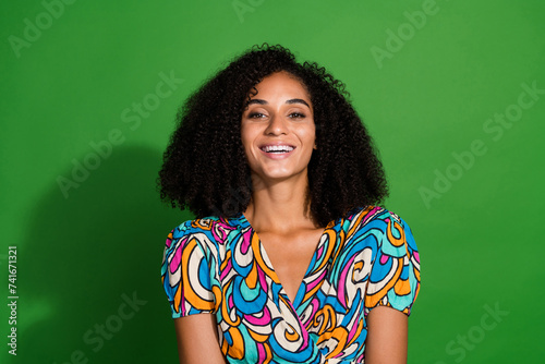 Photo of optimistic glad cute girl wear summer vivid printed clothes isolated on green color background © deagreez
