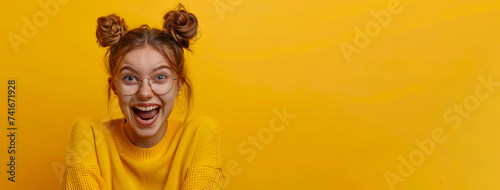 Happy young girl on yellow background