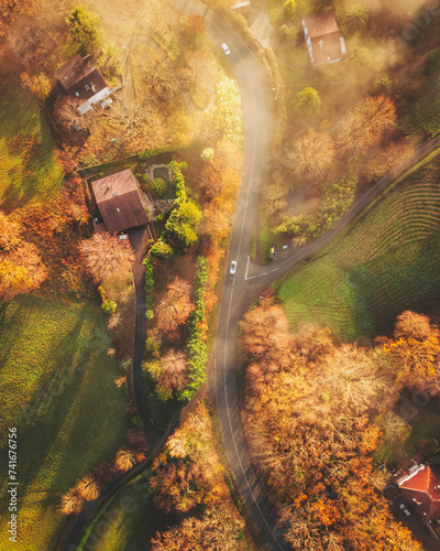 Aerial topdown shot of a road in Ascain at sunrise with mist, French Basque Country, Pyrénées-Atlantiques, Nouvelle-Aquitaine, France. photo