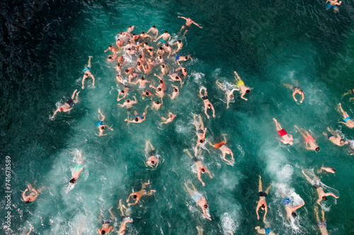 Aerial Drone View of People Swimming in Cold Water in the Winter, Epiphany Christian Holiday, Varna, Bulgaria. photo
