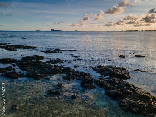 Aerial view of clear reef at sunrise with Gunner's Quoin island in the background, Pointe aux Canonniers coastline, Grand Baie, Mauritius.