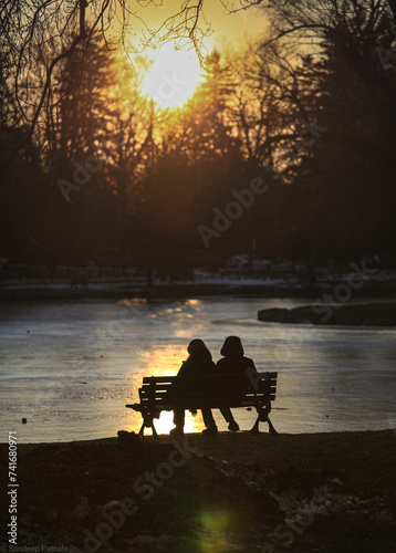 couple sitting on bench in park
