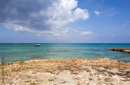 Grand Cayman Island Rocky Shore And A Motorboat