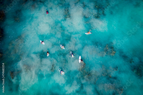 Aerial drone view of surfers catching waves at Trigg beach, Western Australia, Australia. photo