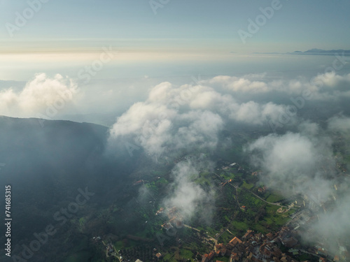 Aerial view of the countryside with residential houses in Capaccio, a small town along the mountains with low clouds, Paestum, Salerno, Campania, italy. photo