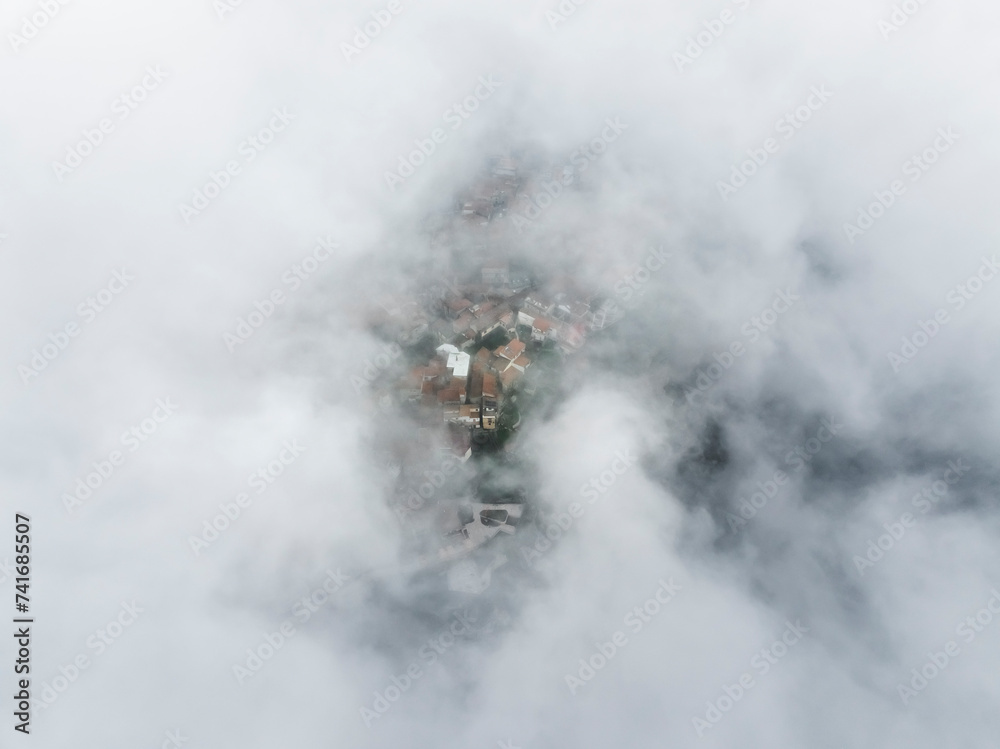 Aerial view of Trentinara, a small town on the mountain peak with low clouds and thick fog Salerno, Campania, italy. Aerial view of Trentinara, a small town on the mountain peak with low clouds and thick fog Salerno, Campania, italy.