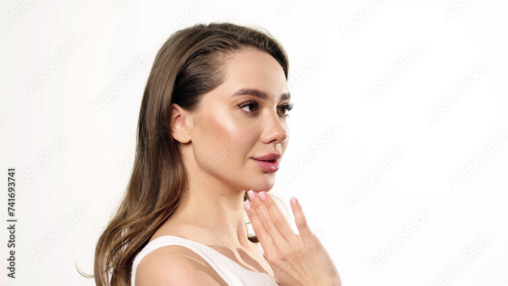 A beautiful woman with clean skin applies moisturizer to her décolleté. Skin care concept, cosmetics and skin care advertising. A beautiful woman with clean skin applies moisturizer to her décolleté. Skin care concept, cosmetics and skin care advertising.